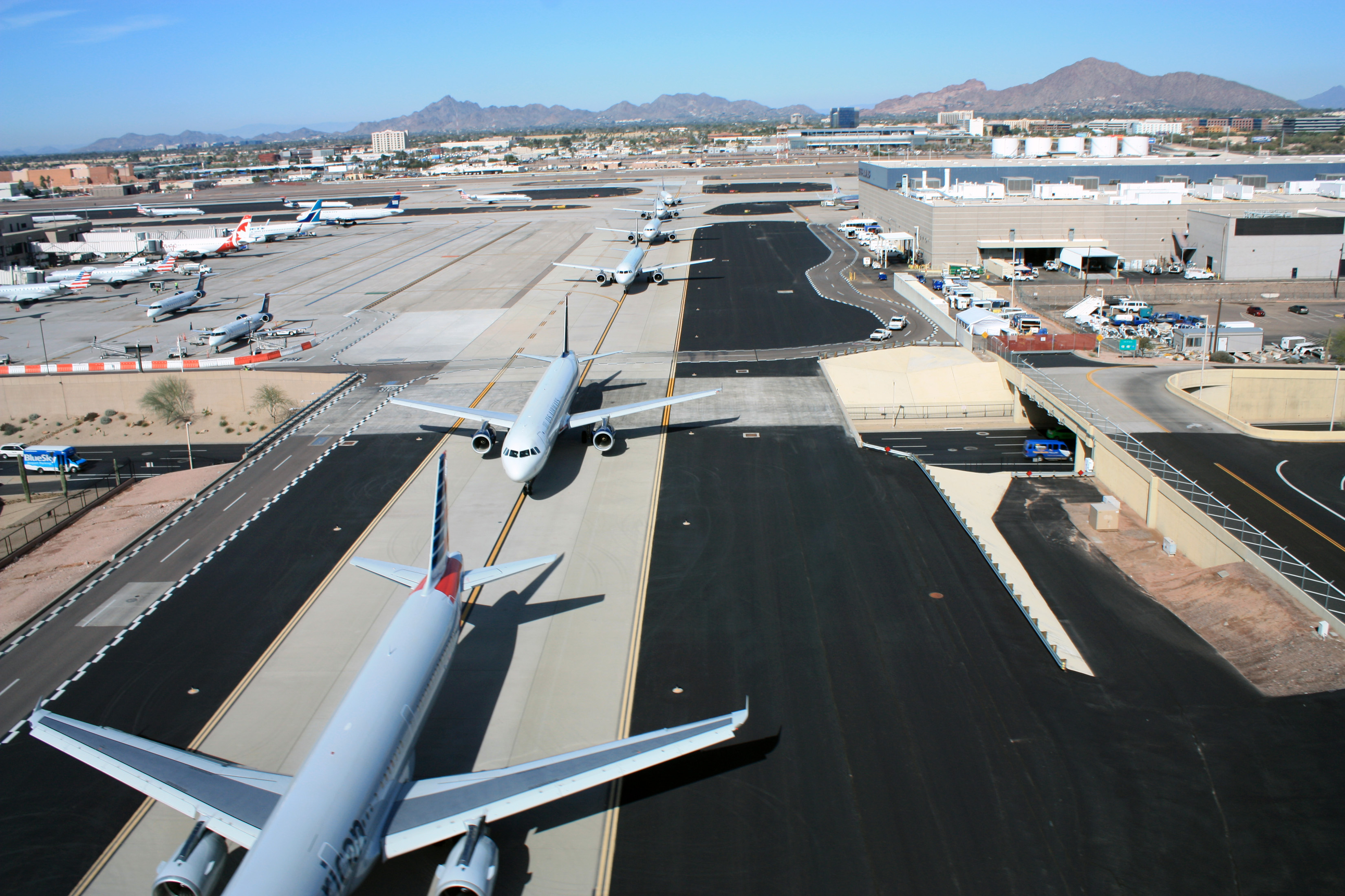 Image of Six Planes Lined Up on the Runway at PHX Sky Harbor International Airport. 