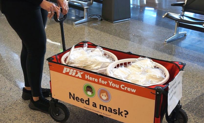 A wagon being pulled with free masks in other PPE supplies.