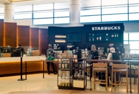 Starbucks coffee bar counter with two people in line.